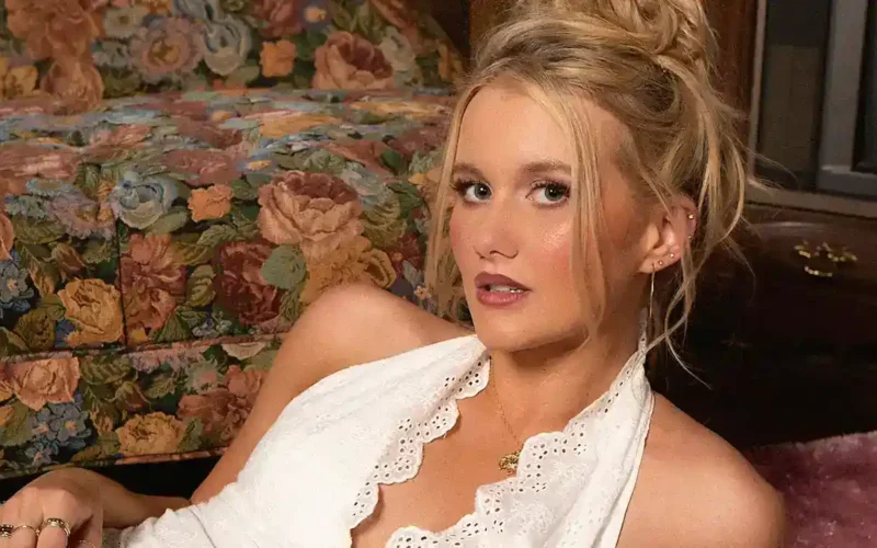Elizabeth Nichols seated for a portrait in a white blouse.