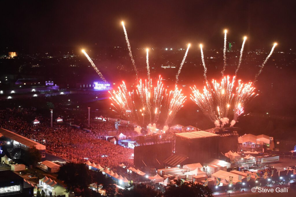 Fireworks illuminate the Bell Stage and festival crowd at night