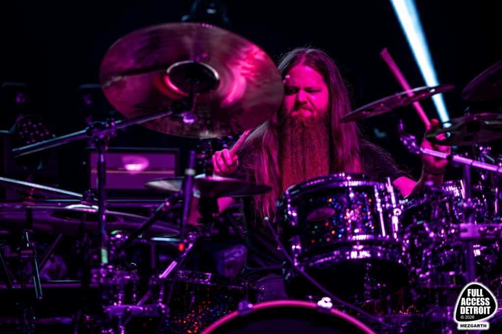 Havok drummer playing under purple stage lights
