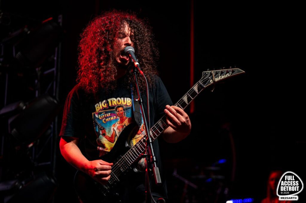 Iron Reagan guitarist playing a black electric guitar