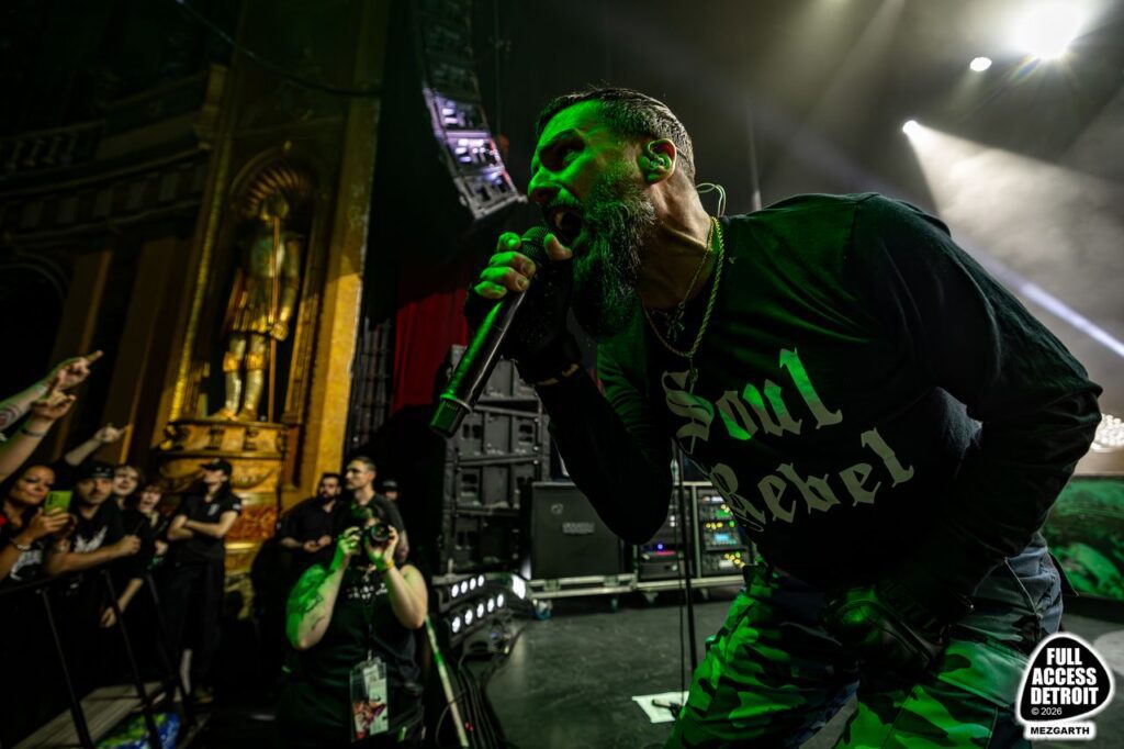 Killswitch Engage singer leaning toward the crowd with a microphone