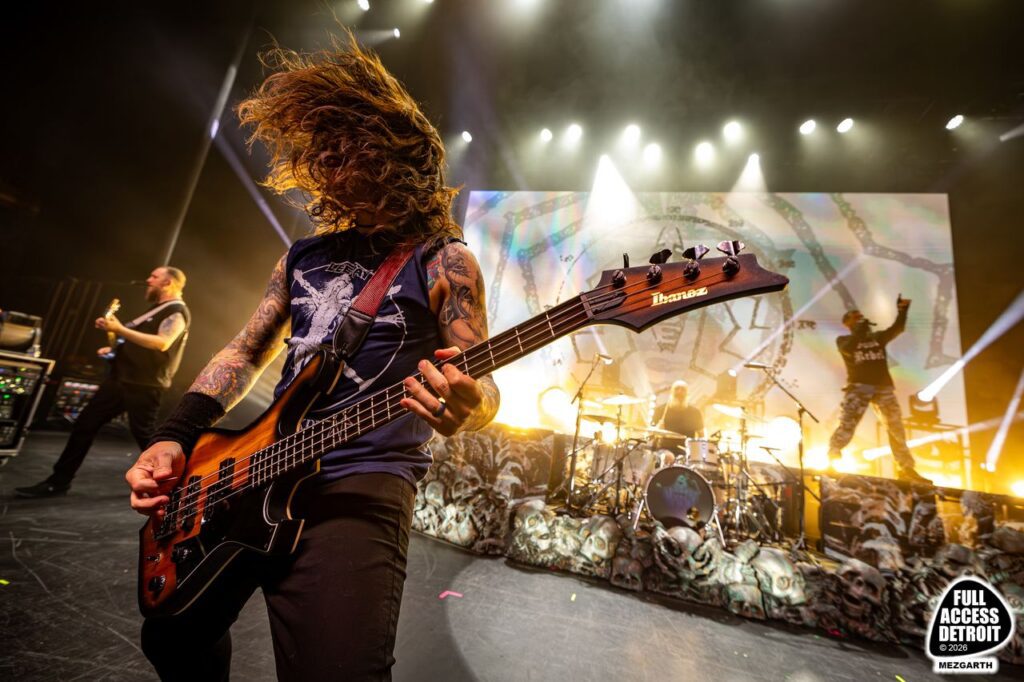 Killswitch Engage bassist playing beside the drum kit
