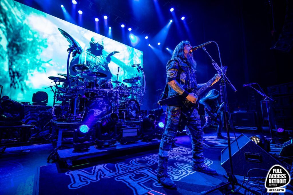 Machine Head performing on stage under blue lights