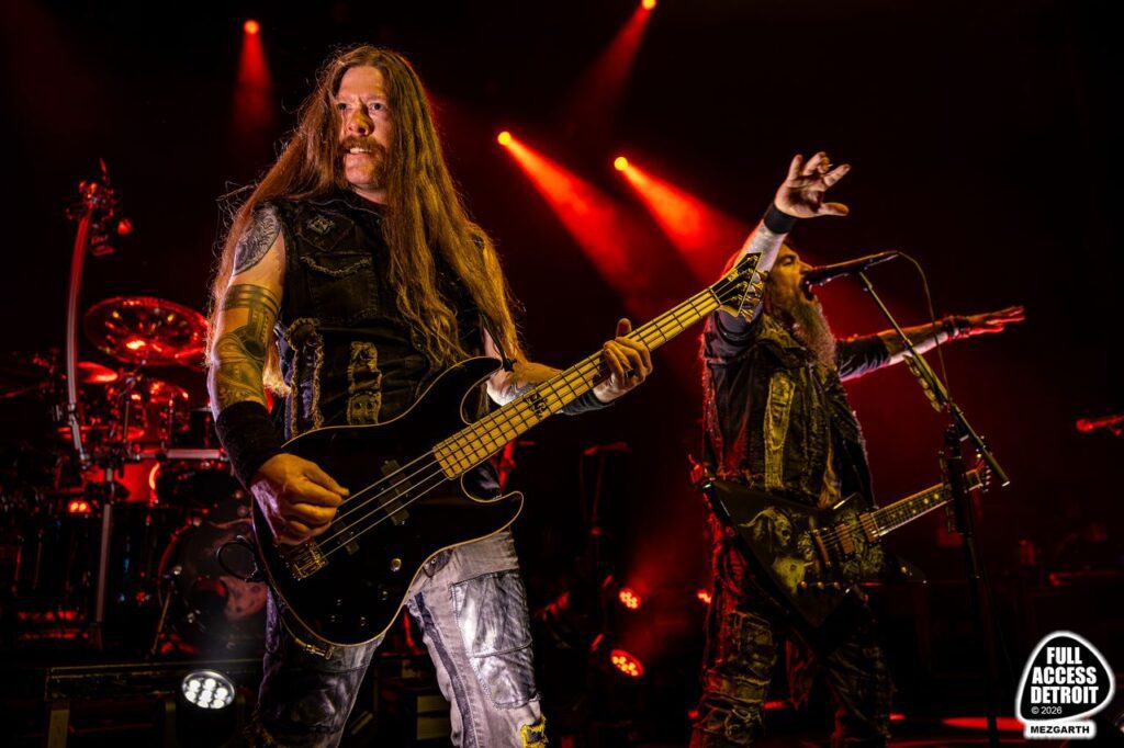 Machine Head guitarist performing under red stage lights