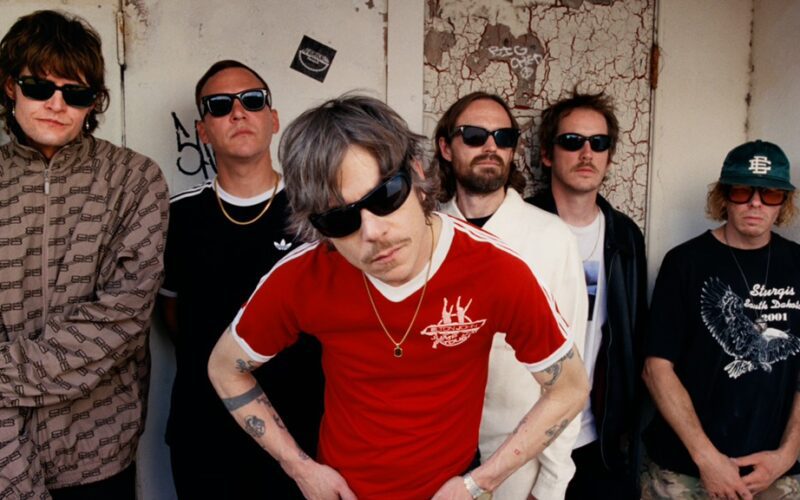 The members of Cage the Elephant posing together indoors