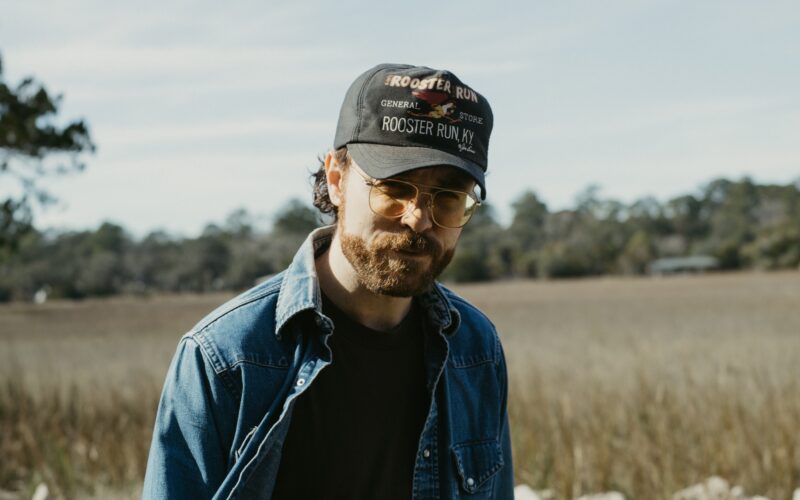 Wyatt McCubbin wearing a cap and denim jacket outdoors.